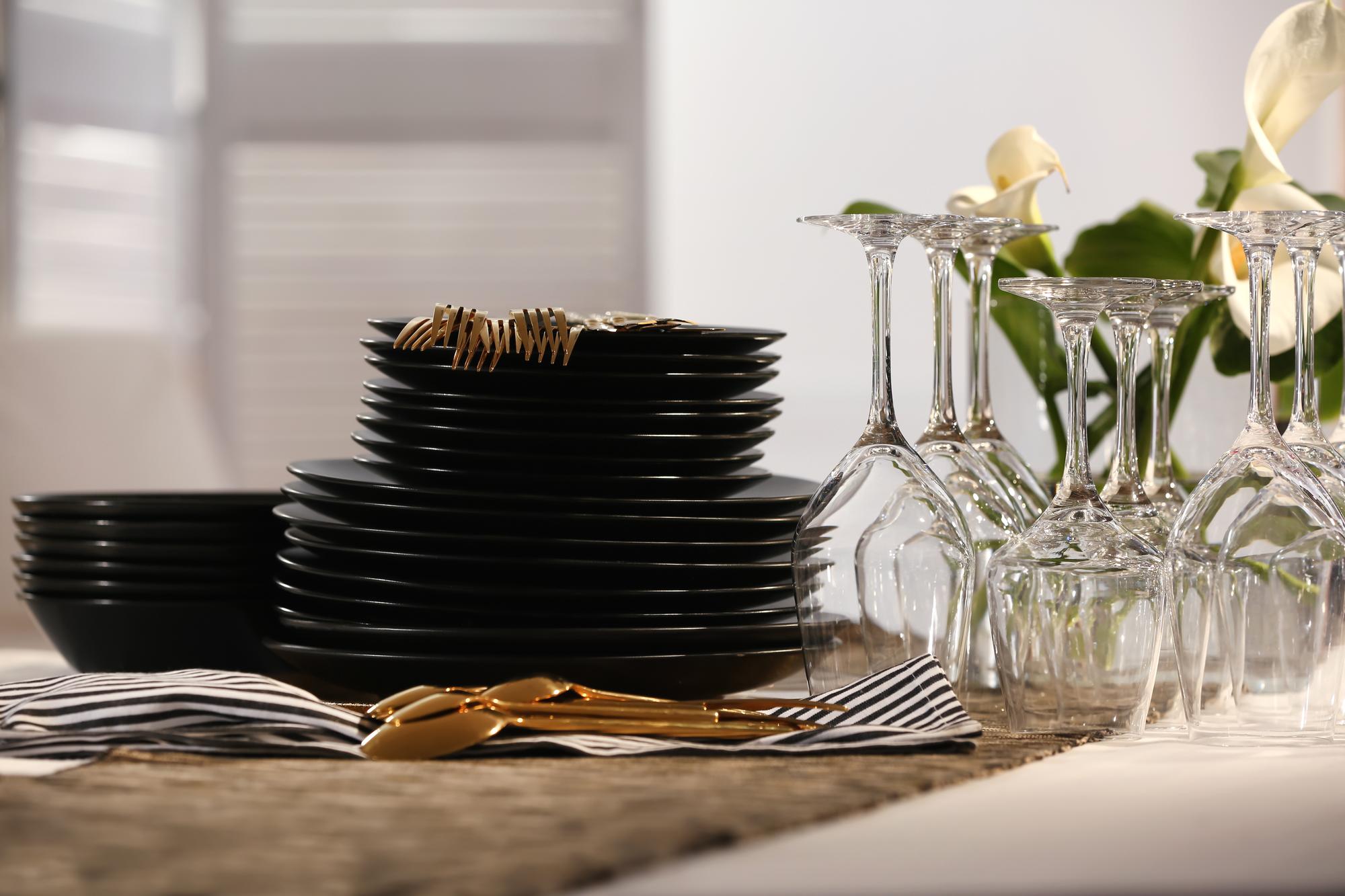 Table with cooking tools and plated dishes
